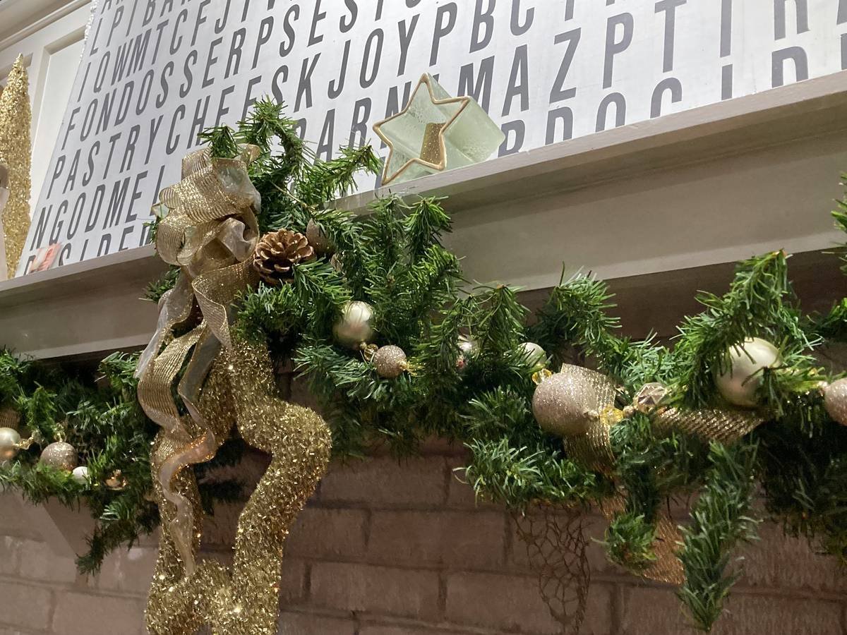 Close-up of budget mantel garland showing layered textures and handmade ornaments