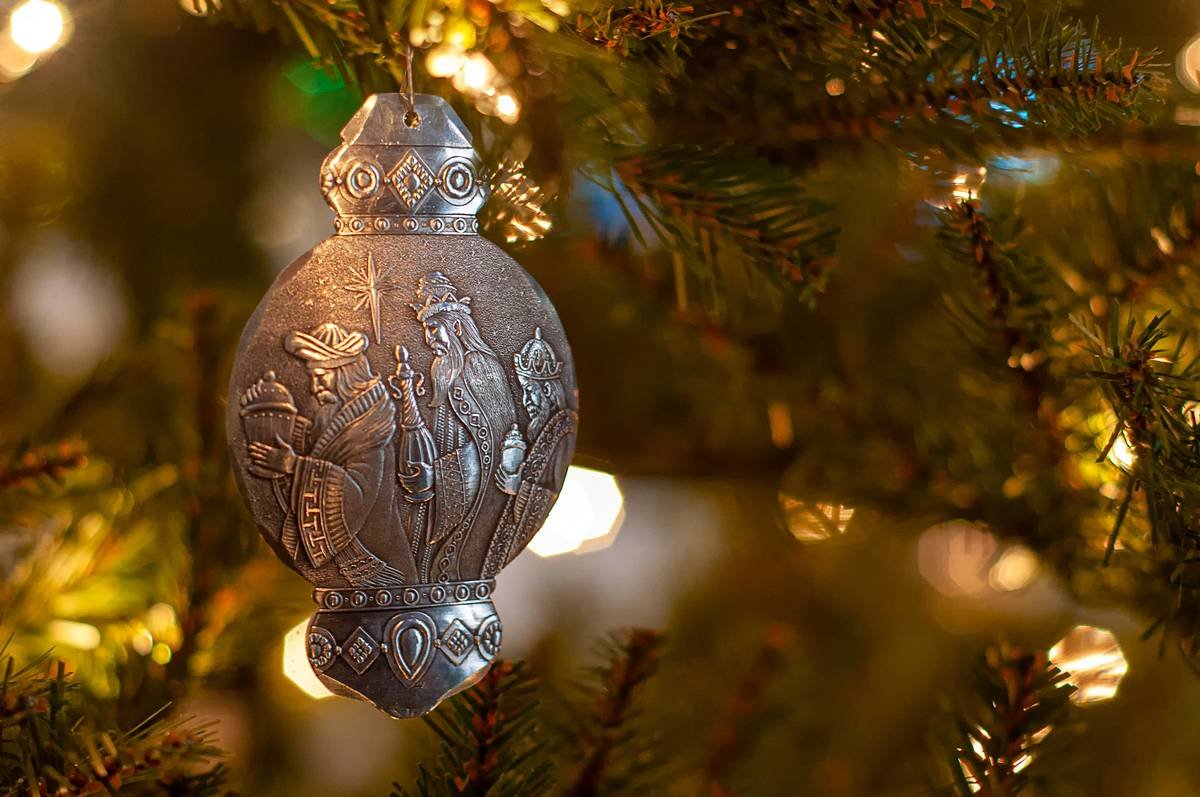 Comparison showing matte finish ornament versus glossy baubles under indoor lighting